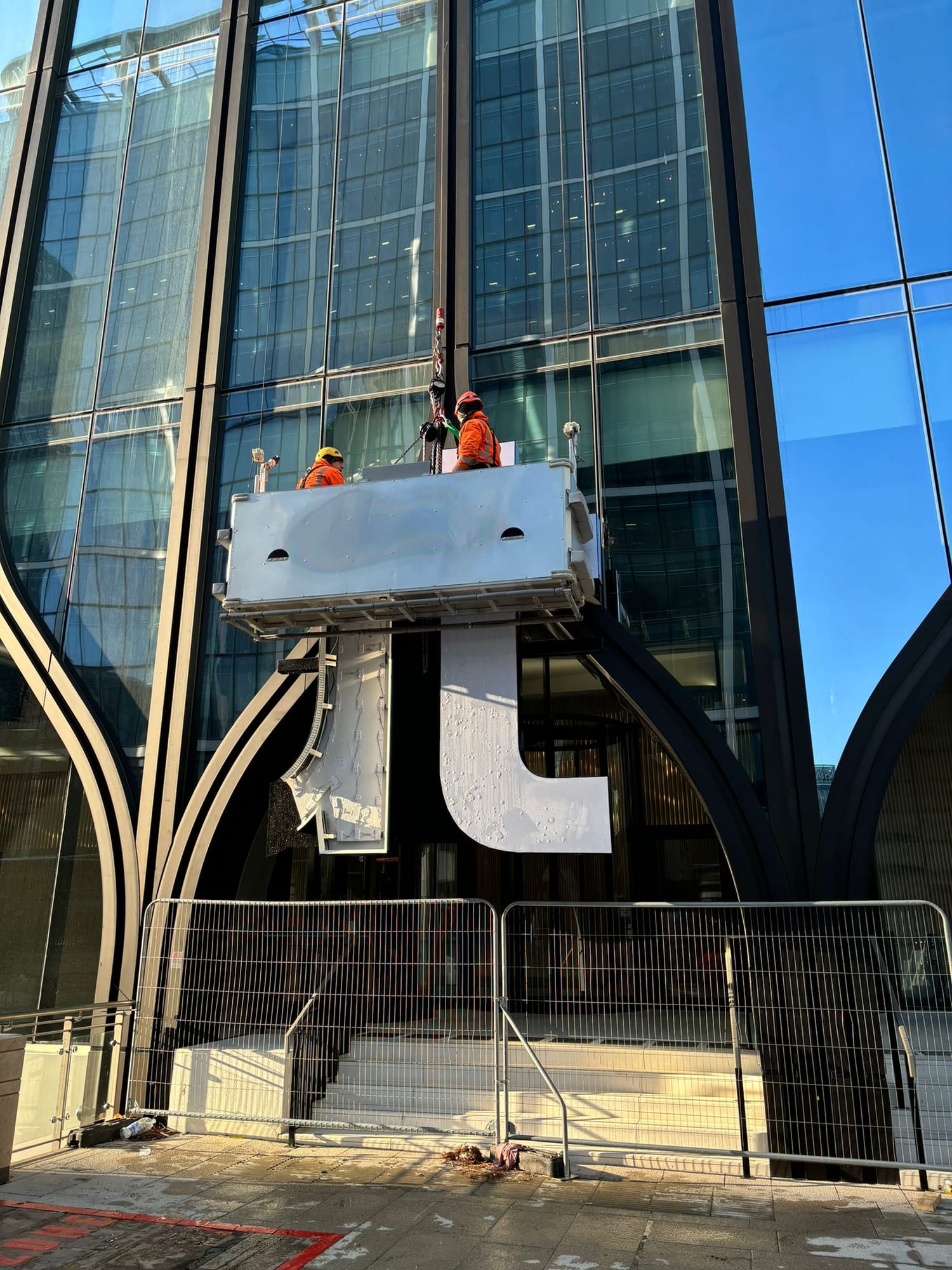 Revolut HQ, Canary Wharf — letters lifted by cradle