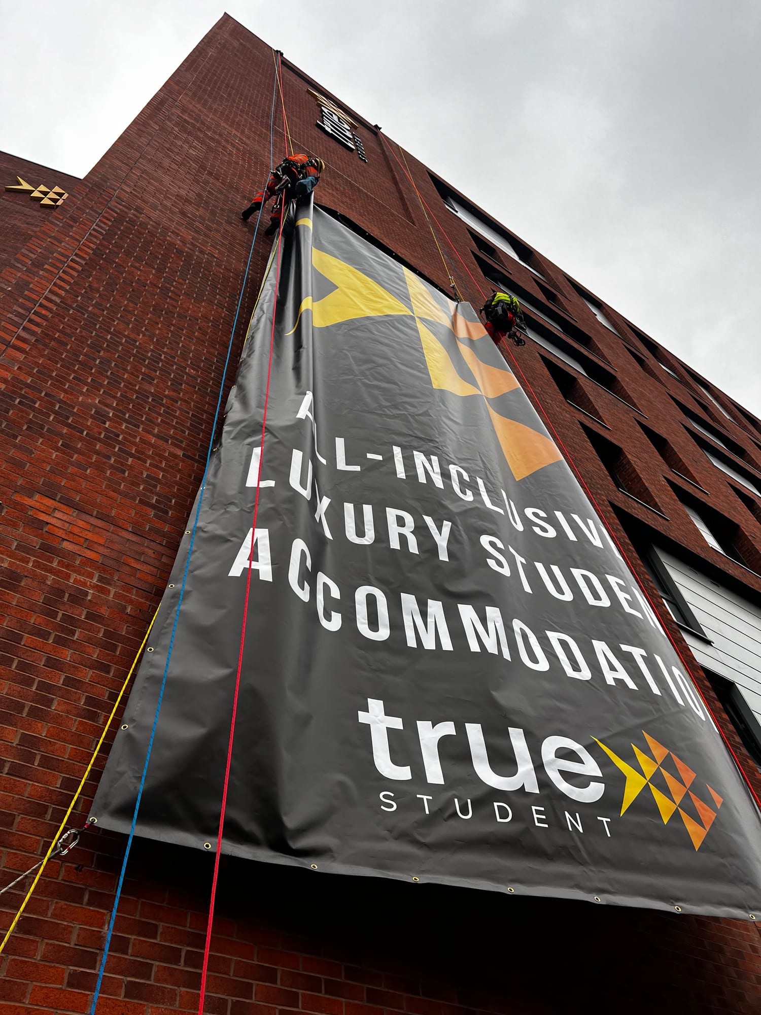 True Student, Birmingham — installing large format banner