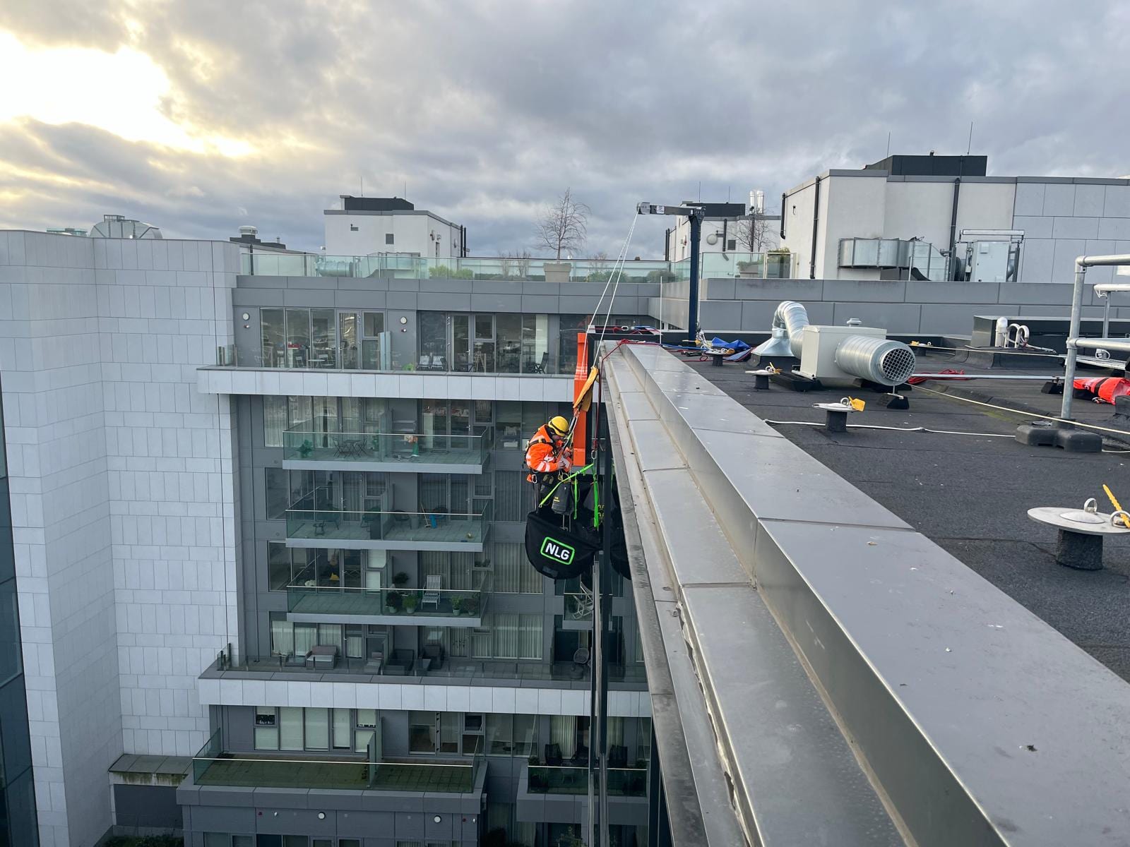 Rope access construction — modern facade parapet