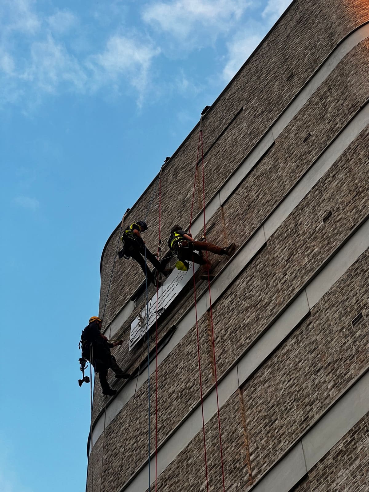 Rope Access signage & display works at height — brick facade brand